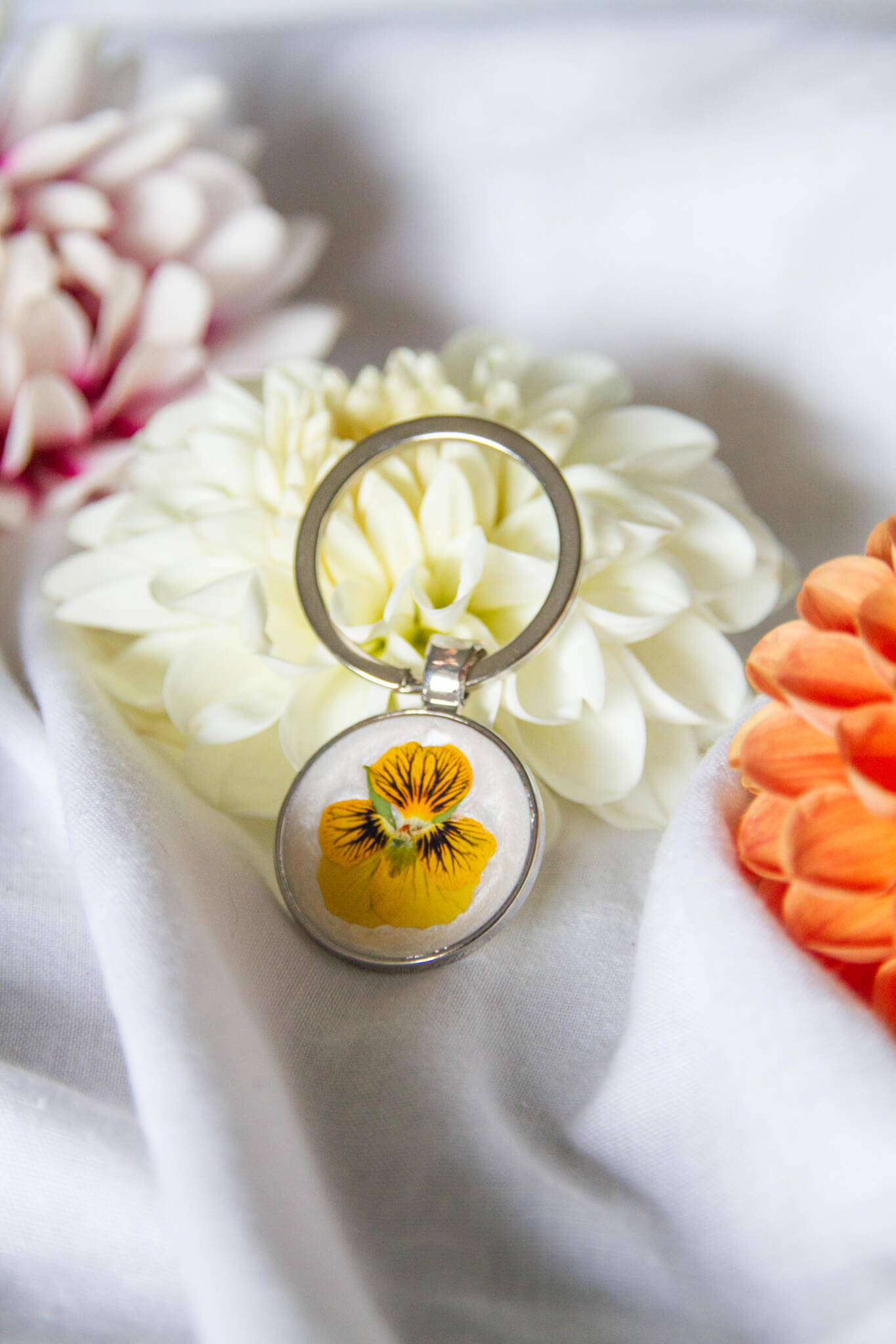 Botanical round keychains- Viola flower set in a 25mm round keychain pendant fitted with a 30mm keyring