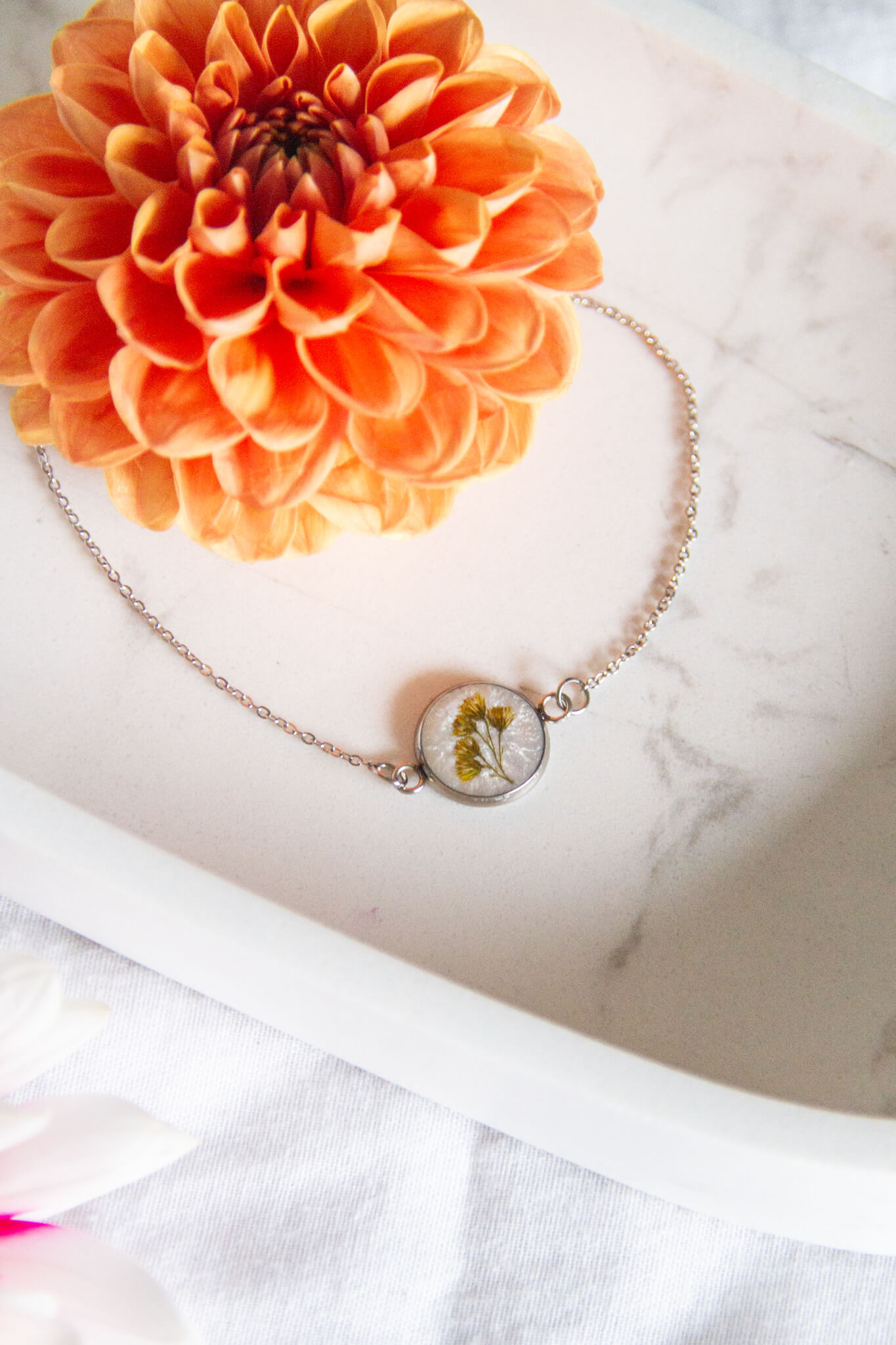 Botanical resin bracelet- Real golden rod flowers set in a 12mm round pendant with a 15-20cm adjustable stainless-steel bracelet.