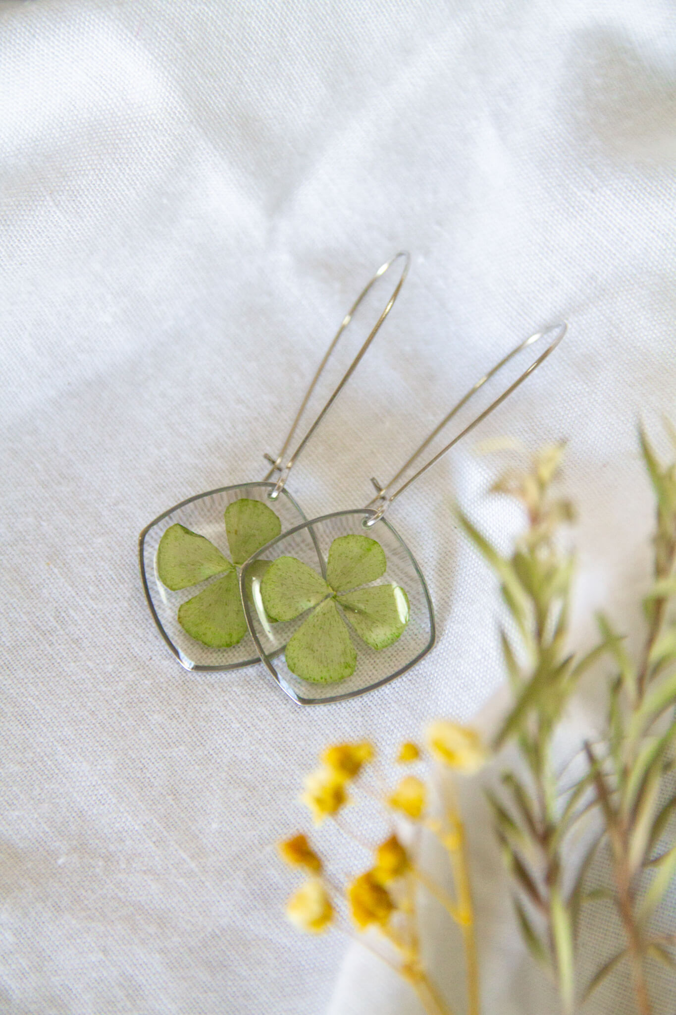 Botanical resin earrings: Four-leaf clover stainless-steel earrings- kidney hooks with large rounded square pendants