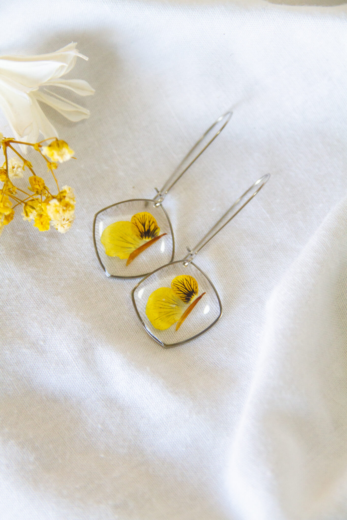 Botanical resin earrings: Yellow Viola stainless-steel earrings- kidney hooks with large rounded pendants